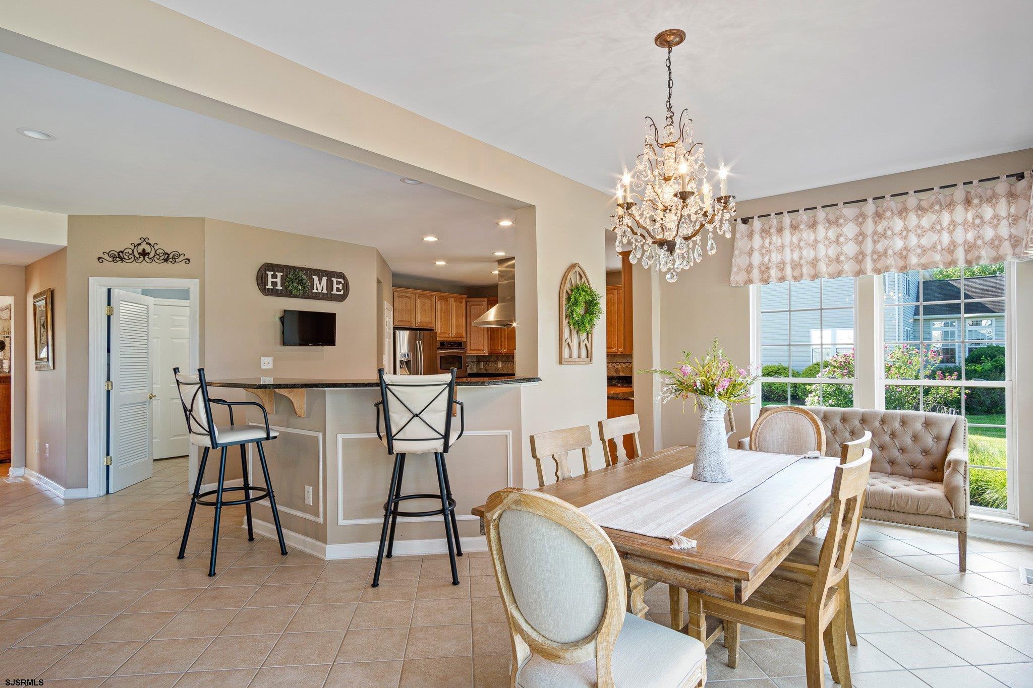 109 Quail Ridge Way Mickleton, NJ 08056 - Photo 36 of 59 a dining room with furniture a chandelier and a rug