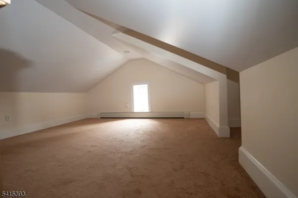 a bathroom with a sink window and mirror