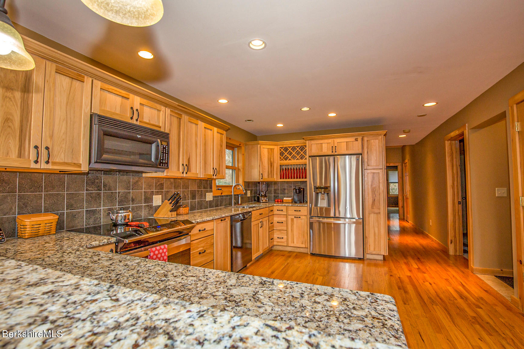 464 Pine Road Otis, MA 01029 - Photo 14 of 43 a large kitchen with stainless steel appliances kitchen island granite countertop a refrigerator and a sink
