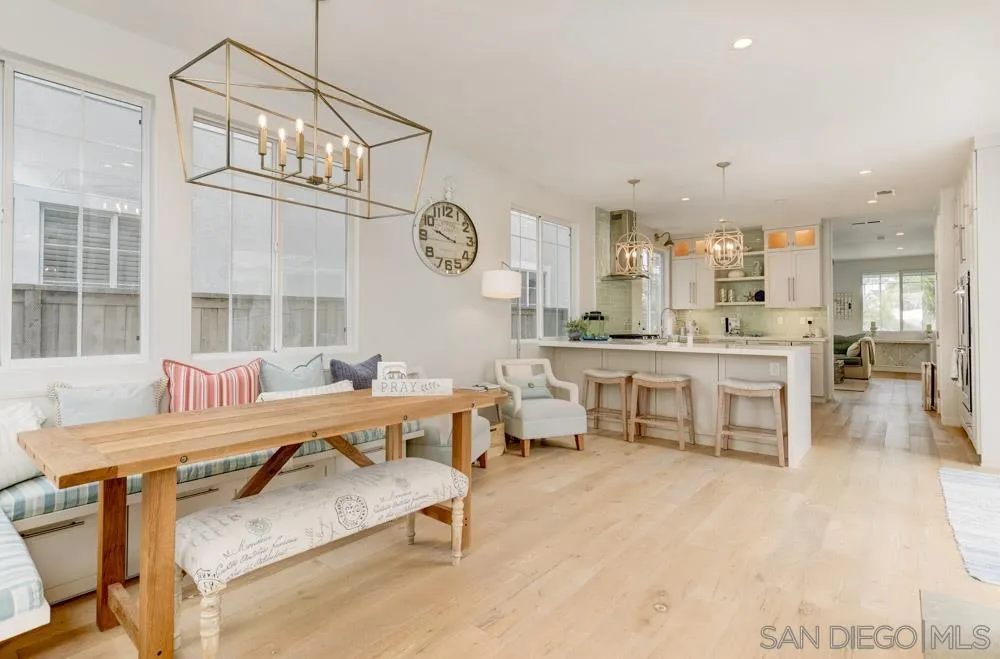 a large living room with stainless steel appliances kitchen island granite countertop furniture and a large window