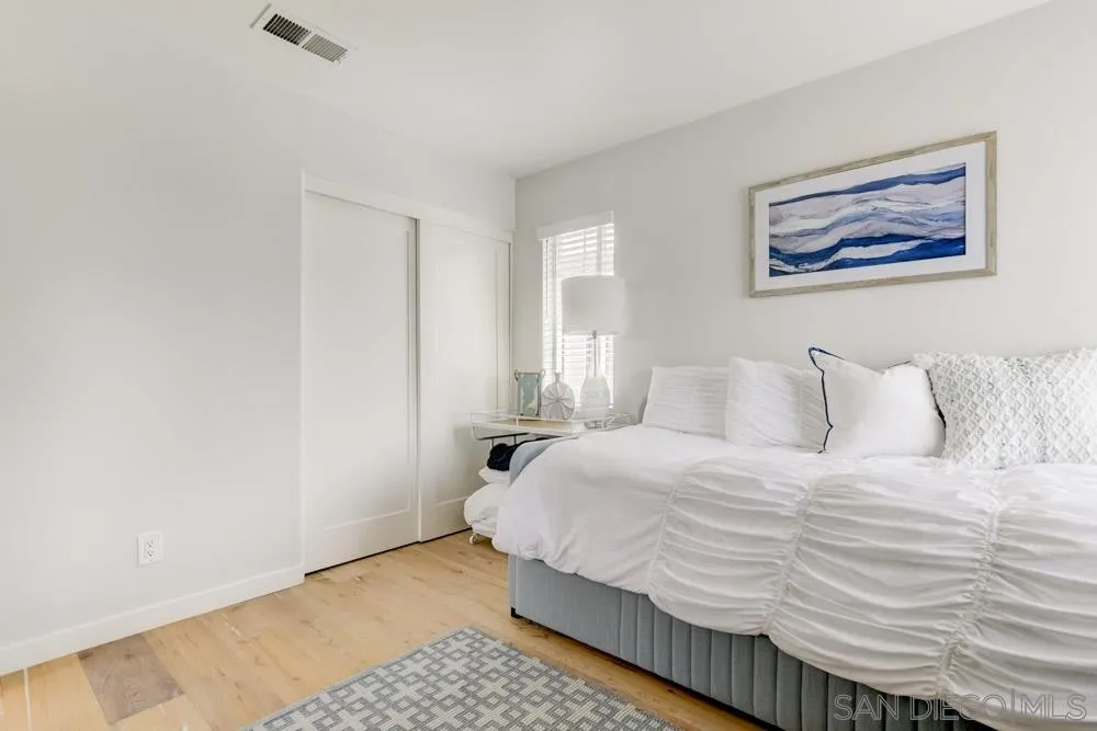 124 Breakwater Road Carlsbad, CA 92011 - Photo 12 of 20 a bedroom with a bed and painting on the wall