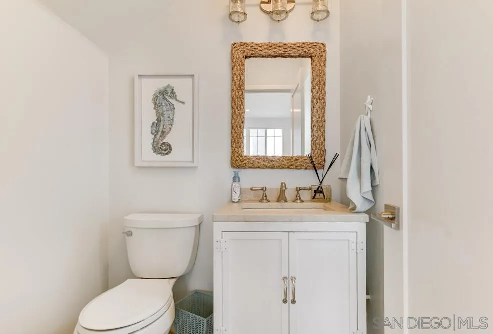 124 Breakwater Road Carlsbad, CA 92011 - Photo 8 of 20 a bathroom with a toilet sink and mirror