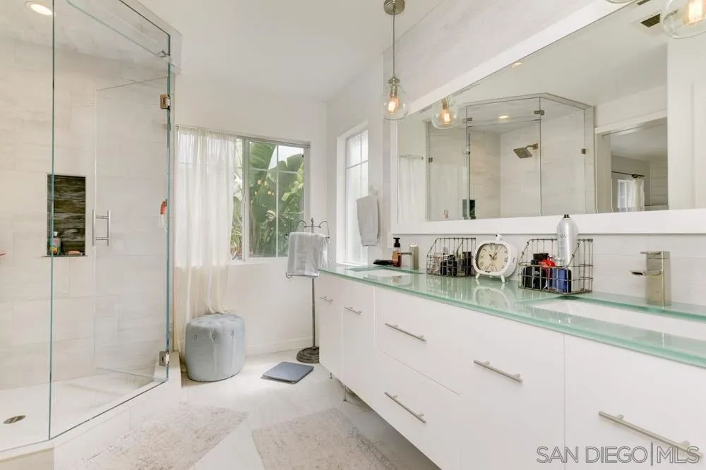 124 Breakwater Road Carlsbad, CA 92011 - Photo 10 of 20 a bathroom with a sink a mirror and a shower