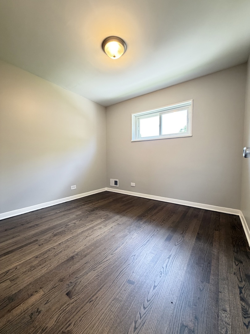 1820 169th Street Hazel Crest, IL 60429 - Photo 18 of 23 an empty room with wooden floor and windows