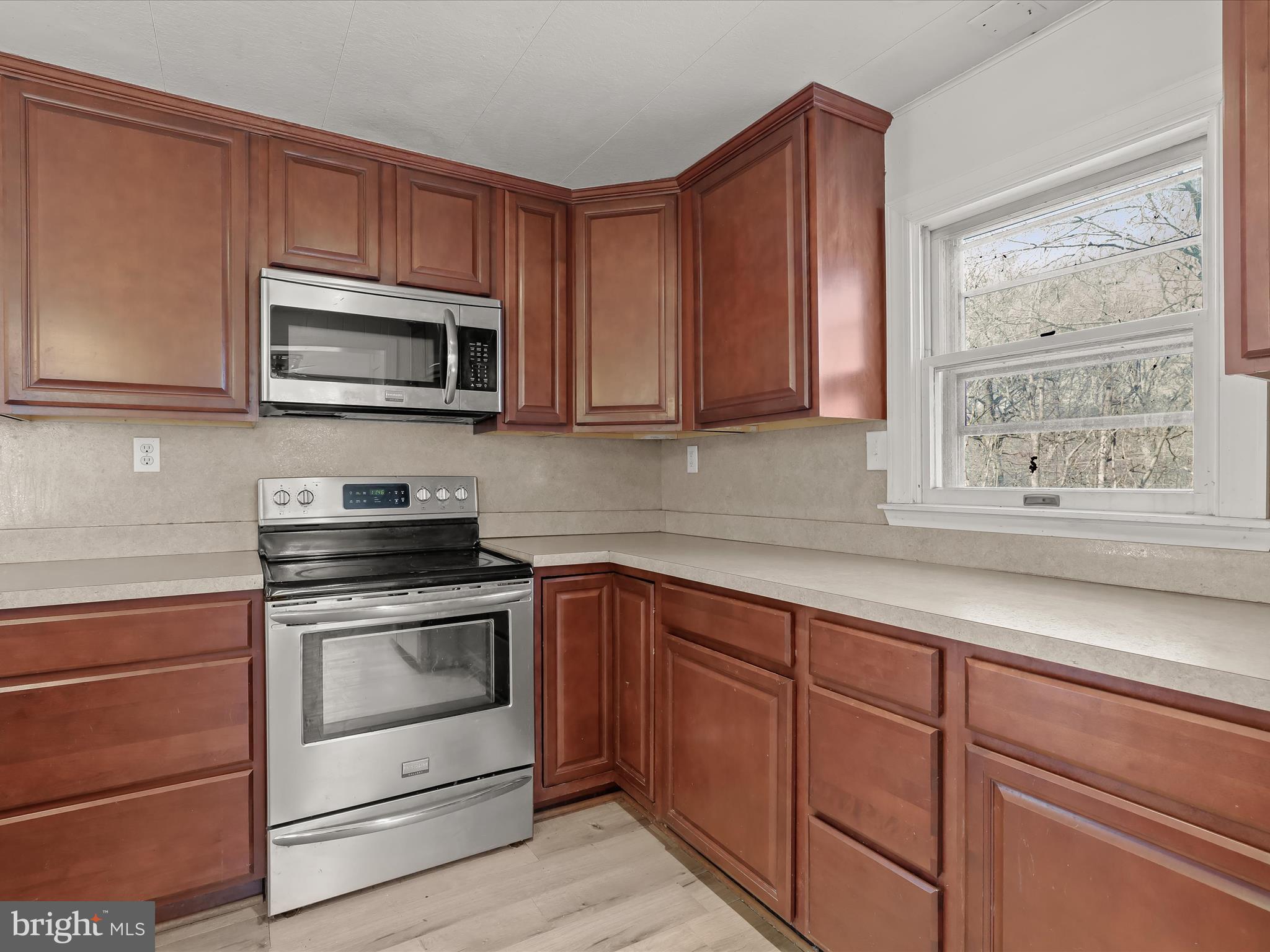 1970 Lower Marlboro Road Huntingtown, MD 20639 - Photo 19 of 81 a kitchen with sink cabinets and stainless steel appliances