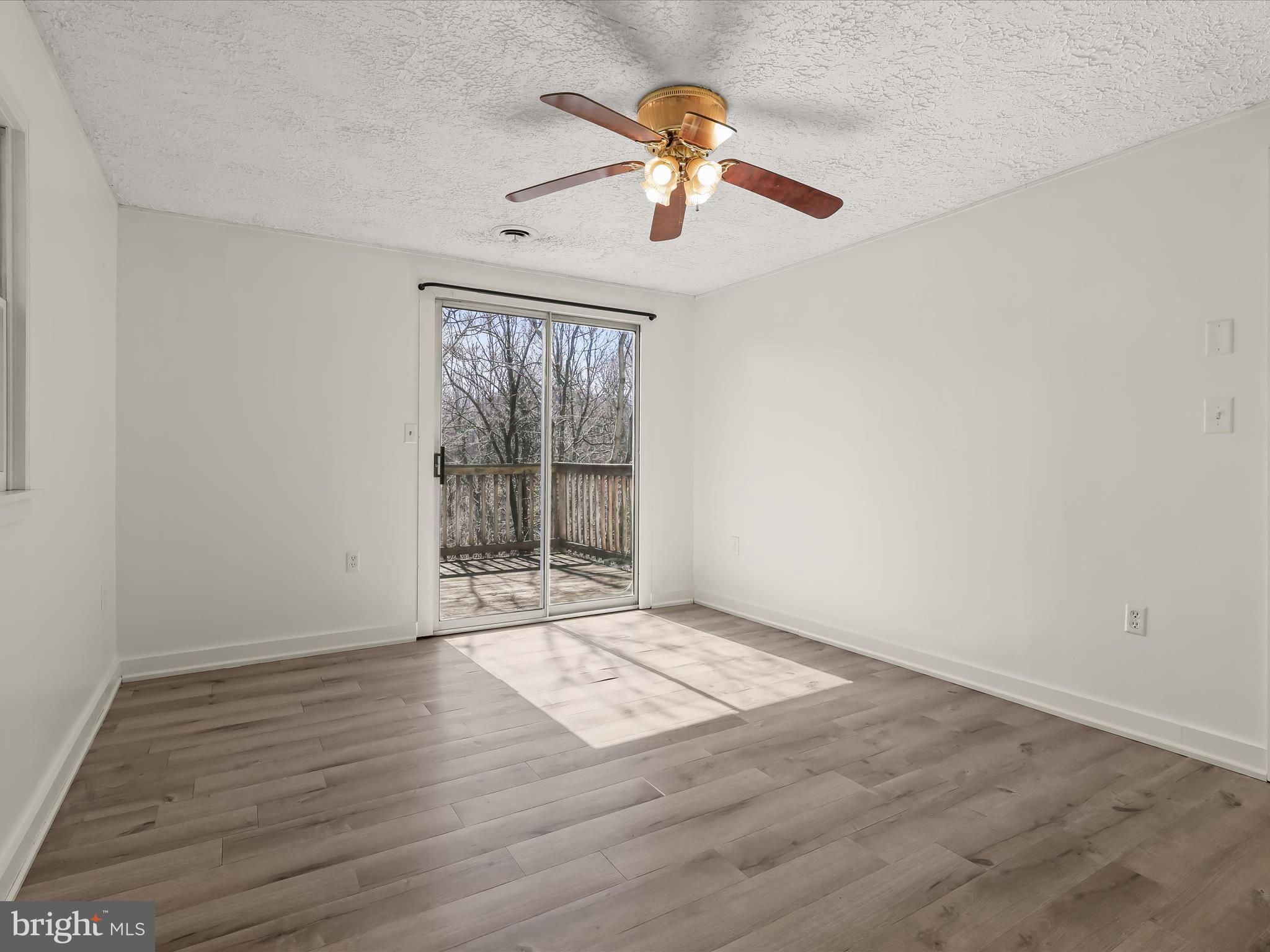 1970 Lower Marlboro Road Huntingtown, MD 20639 - Photo 38 of 81 an empty room with wooden floor fan and windows