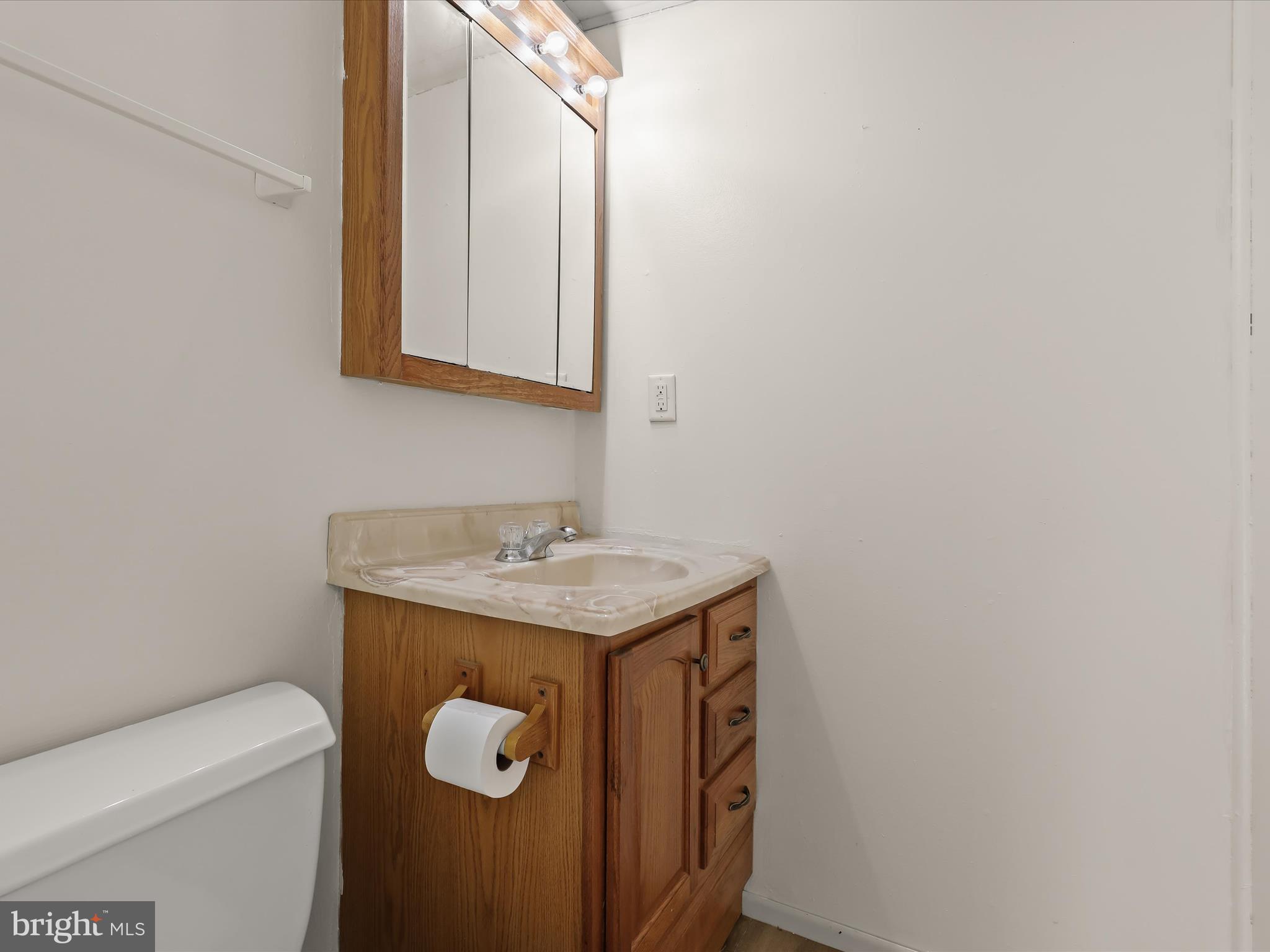 1970 Lower Marlboro Road Huntingtown, MD 20639 - Photo 43 of 81 a bathroom with a granite countertop toilet and a sink