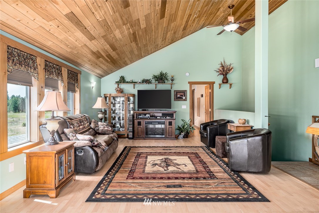 19922 South Smythe Road Spangle, WA 99031 - Photo 2 of 37 a living room with furniture flat screen tv and a fireplace