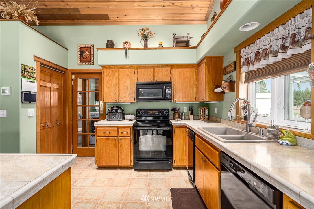 19922 South Smythe Road Spangle, WA 99031 - Photo 5 of 37 a kitchen with stainless steel appliances granite countertop a sink stove and refrigerator