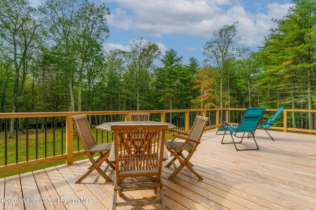 a roof deck with table and chairs and wooden floor