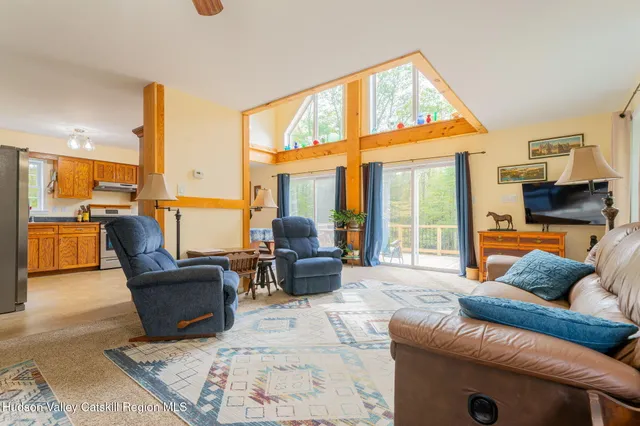 a living room with furniture and floor to ceiling windows