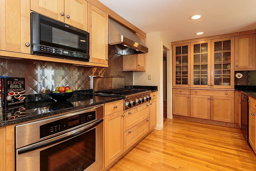 30 Munroe Road Lexington, MA 02421 - Photo 11 of 29 a kitchen with stainless steel appliances granite countertop a stove and a microwave