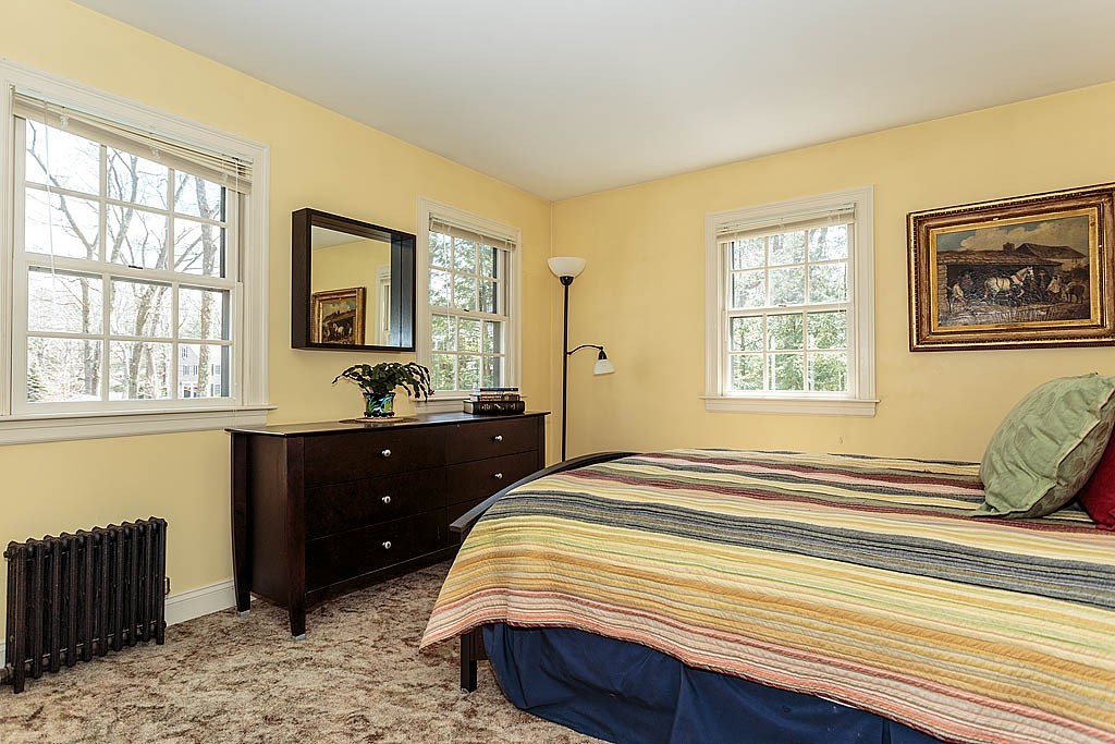 30 Munroe Road Lexington, MA 02421 - Photo 21 of 29 a bedroom with a bed and wooden floor