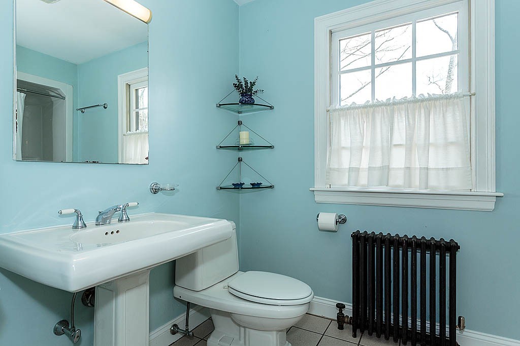30 Munroe Road Lexington, MA 02421 - Photo 23 of 29 a bathroom with a sink a toilet and a window