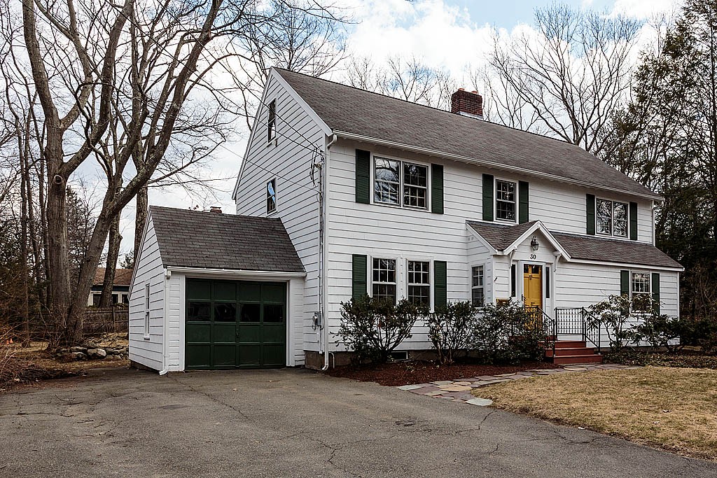 30 Munroe Road Lexington, MA 02421 - Photo 24 of 29 a front view of a house with a garden and trees