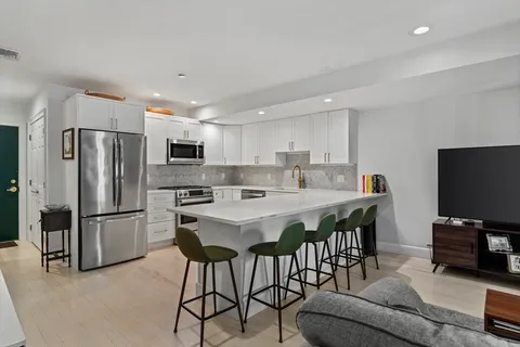 a kitchen with stainless steel appliances a refrigerator a stove a microwave and a refrigerator