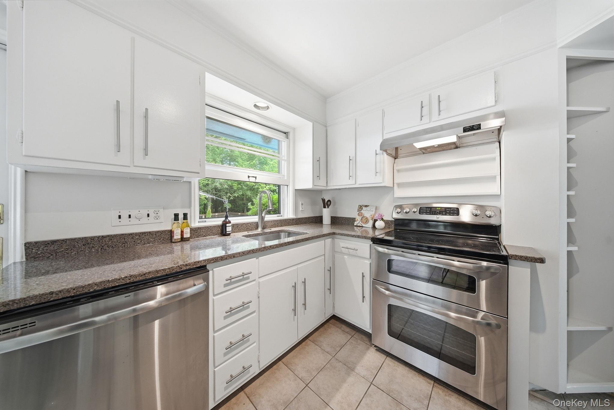 172 Wards Road Livingston Manor, NY 12758 - Photo 13 of 47 Kitchen featuring white cabinetry, dark speckled countertops, stainless steel appliances, and tiled flooring