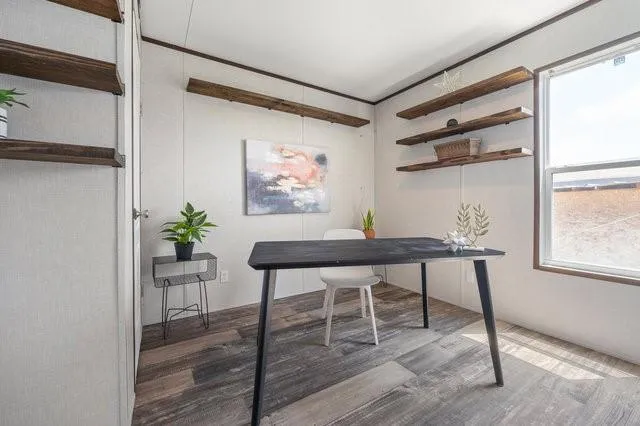a view of a workspace with furniture window and wooden floor