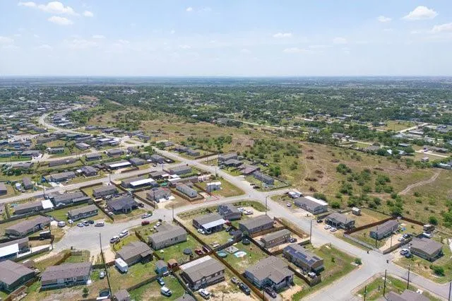 an aerial view of residential building with green space