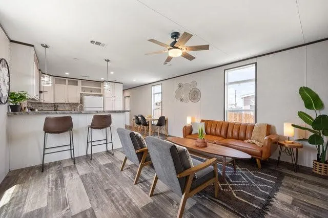 a living room with lots of furniture and a wooden floor