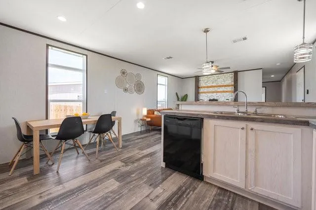 a kitchen with stainless steel appliances granite countertop wooden floors and white cabinets