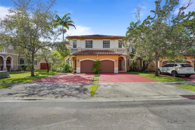 a front view of a house with a yard and a garage