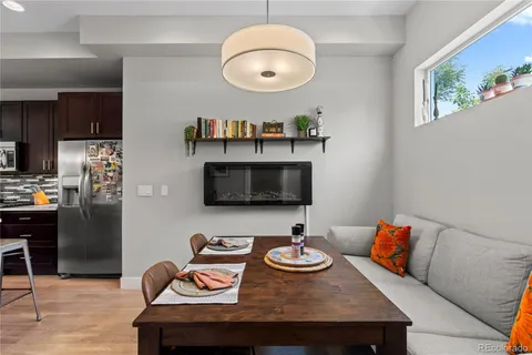 a living room with furniture kitchen view and a window