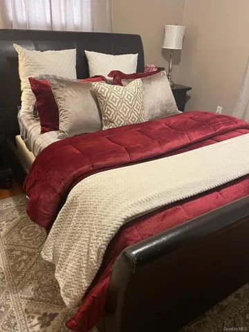 a bedroom with a bed and a night stand