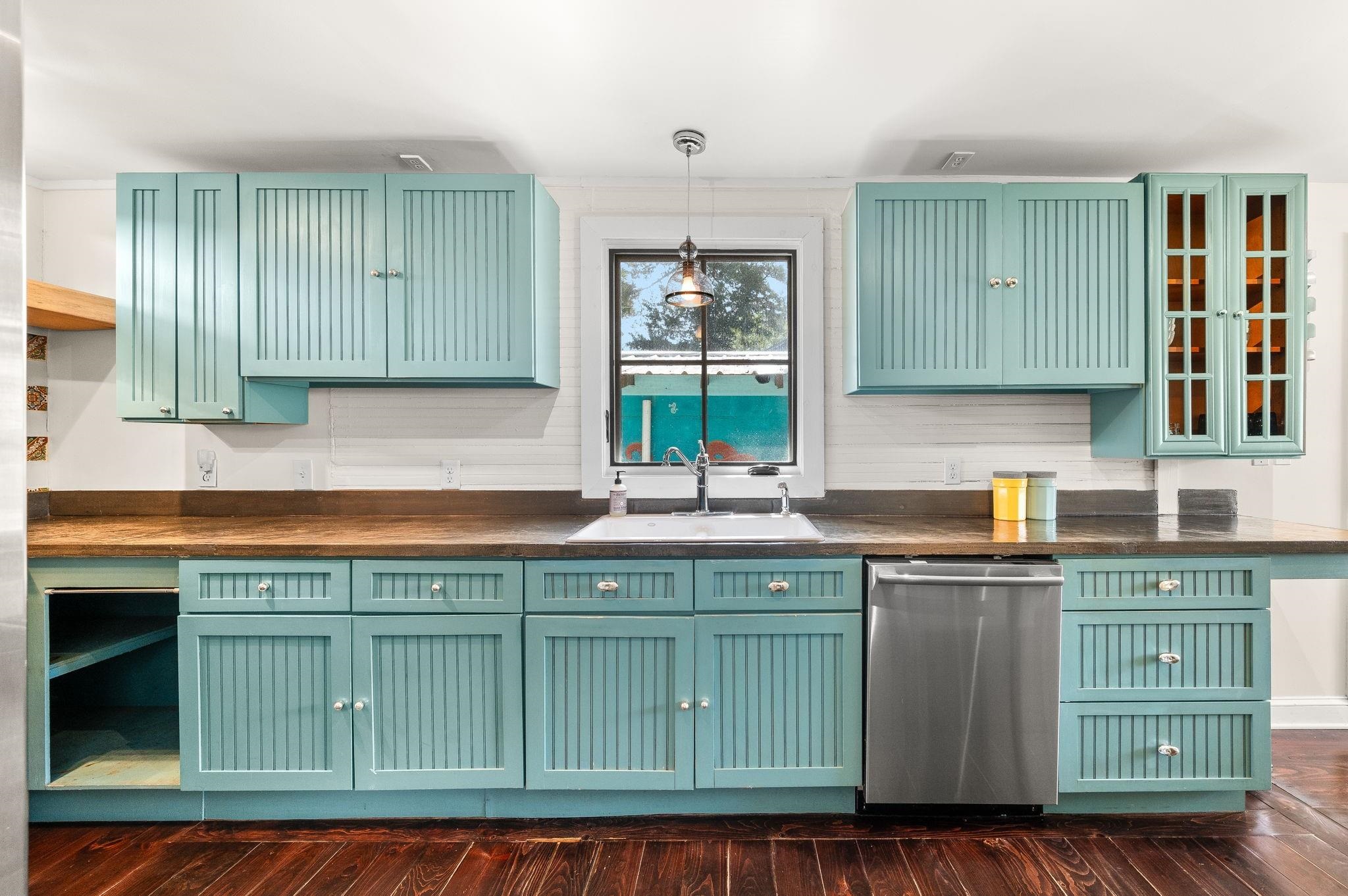 73 Kings Ferry Way St. Augustine, FL 32084 - Photo 21 of 71 a kitchen with kitchen island granite countertop a sink a counter space and cabinets