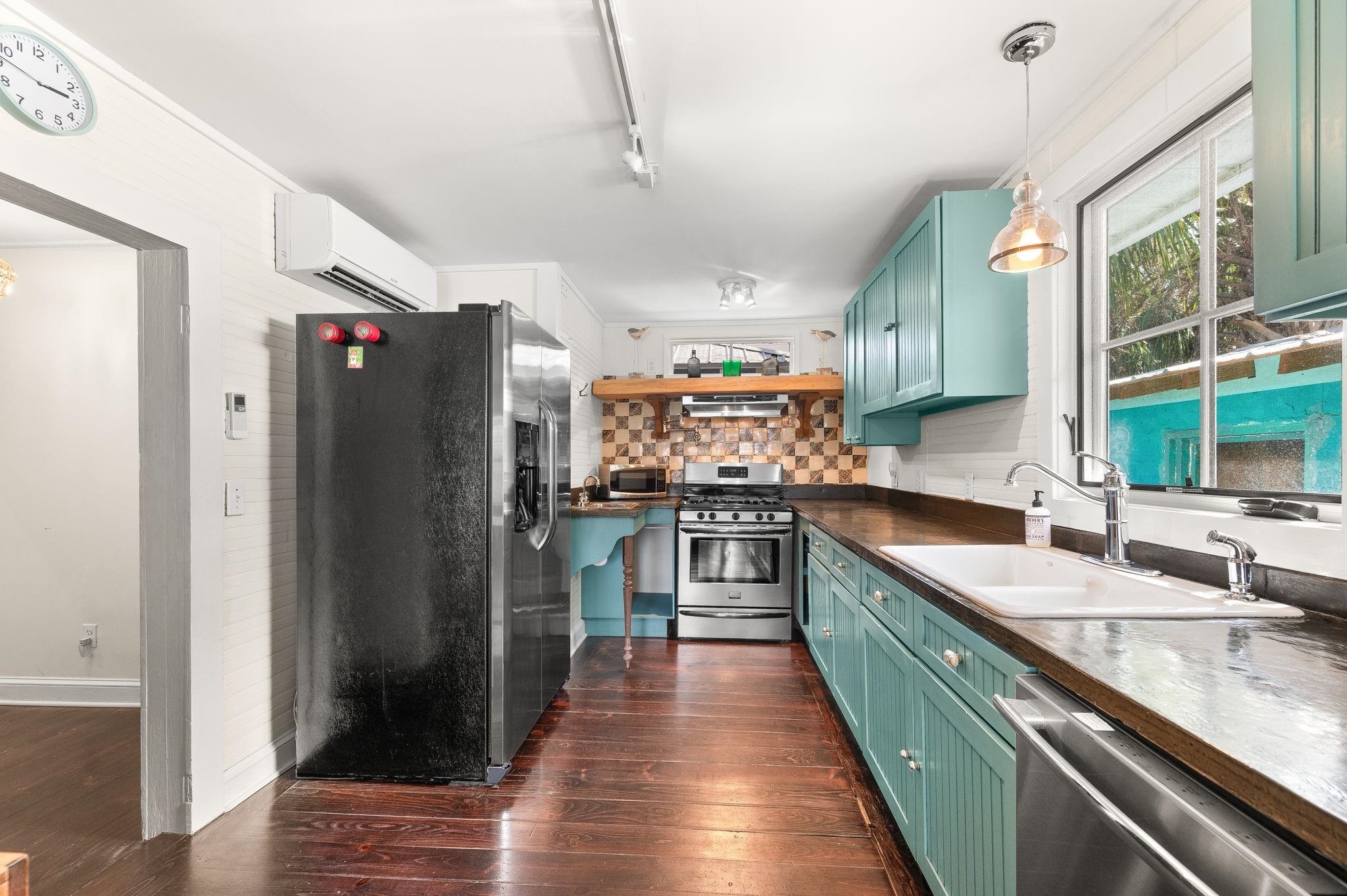 73 Kings Ferry Way St. Augustine, FL 32084 - Photo 22 of 71 a kitchen with stainless steel appliances granite countertop a refrigerator a sink dishwasher a stove and white countertops with wooden floor