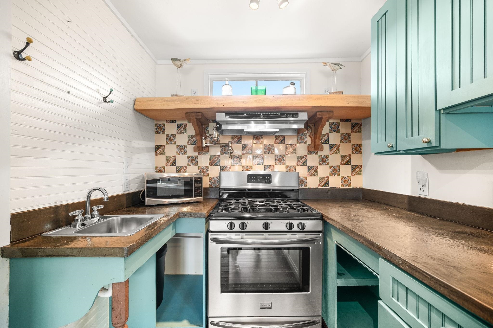 73 Kings Ferry Way St. Augustine, FL 32084 - Photo 26 of 71 a kitchen with a sink a stove and cabinets