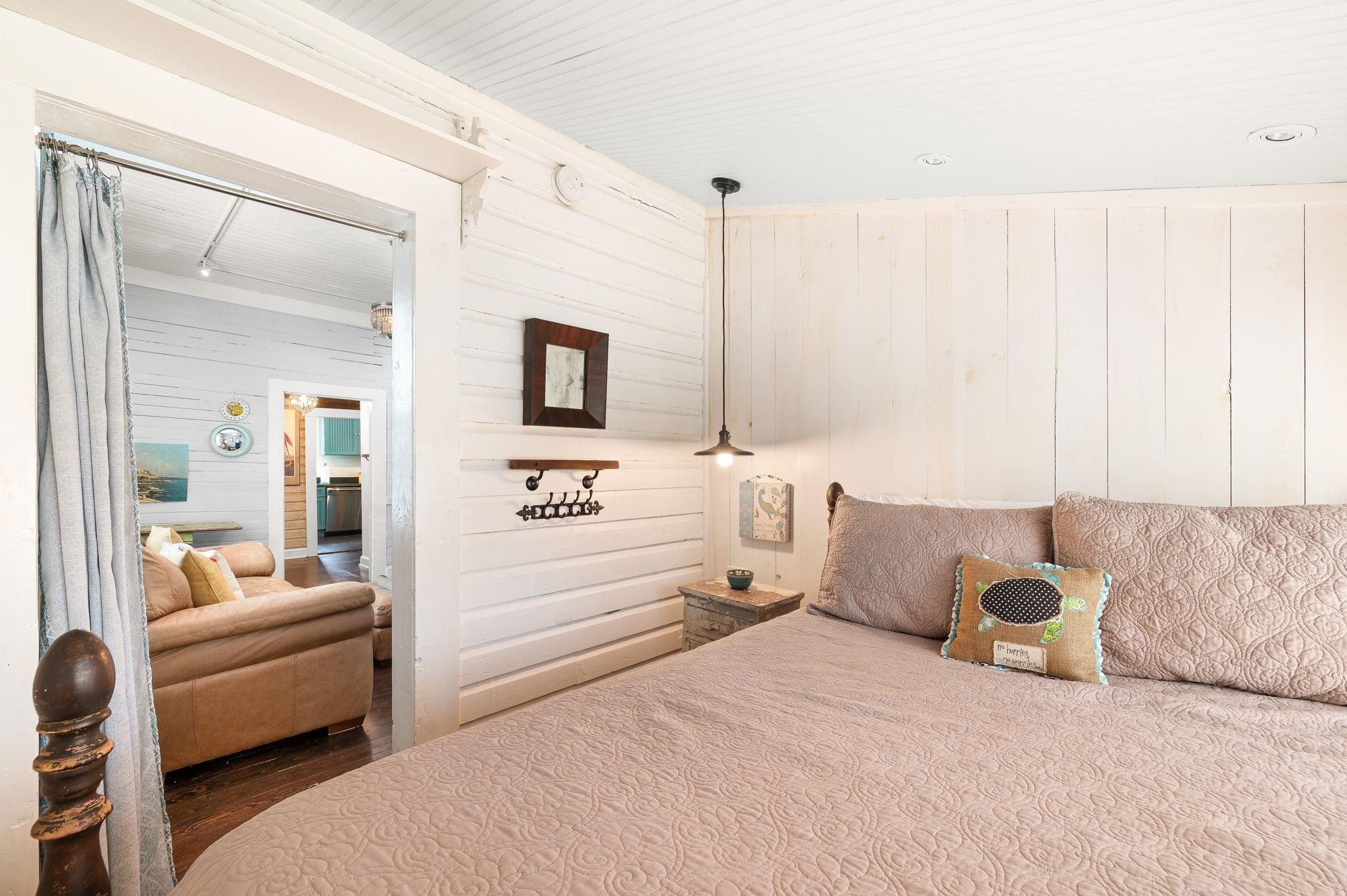 73 Kings Ferry Way St. Augustine, FL 32084 - Photo 39 of 71 a spacious bedroom with a bed a couch and a flat tv screen