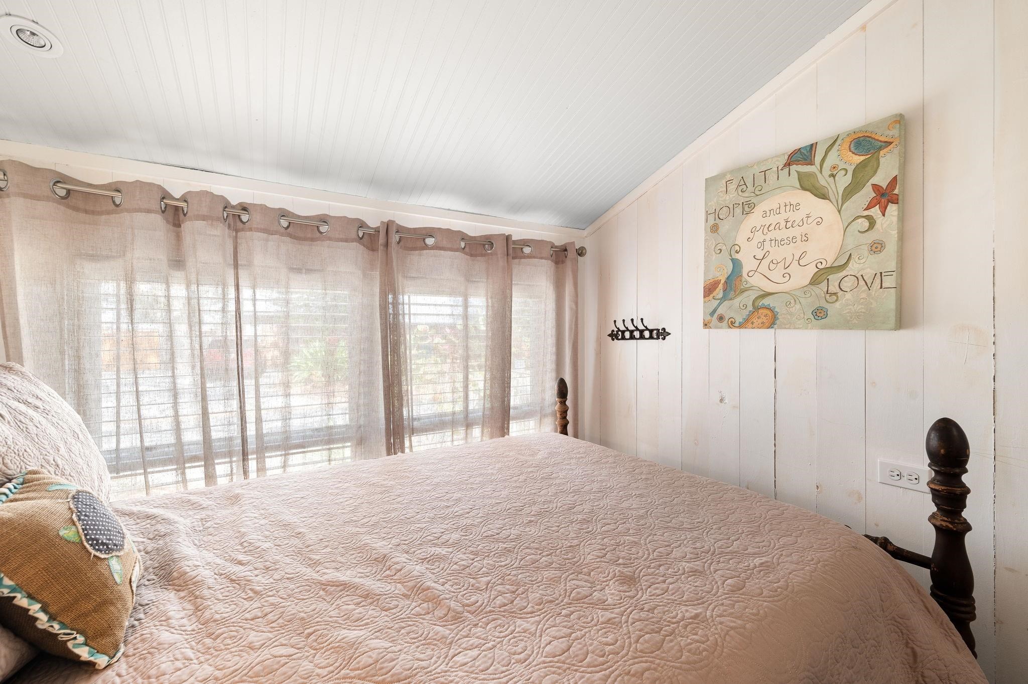 73 Kings Ferry Way St. Augustine, FL 32084 - Photo 40 of 71 a bedroom with a bed and a large window