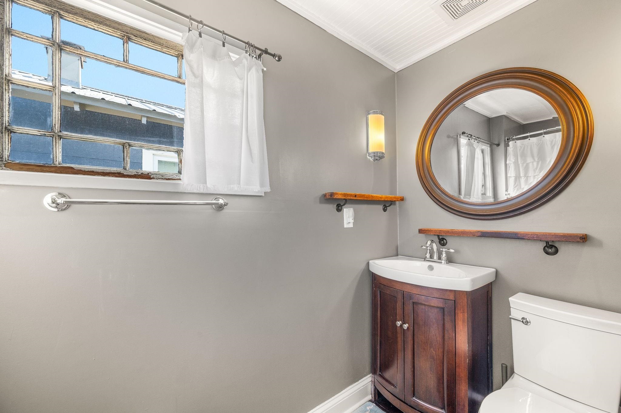 73 Kings Ferry Way St. Augustine, FL 32084 - Photo 43 of 71 a bathroom with a sink a mirror and a toilet