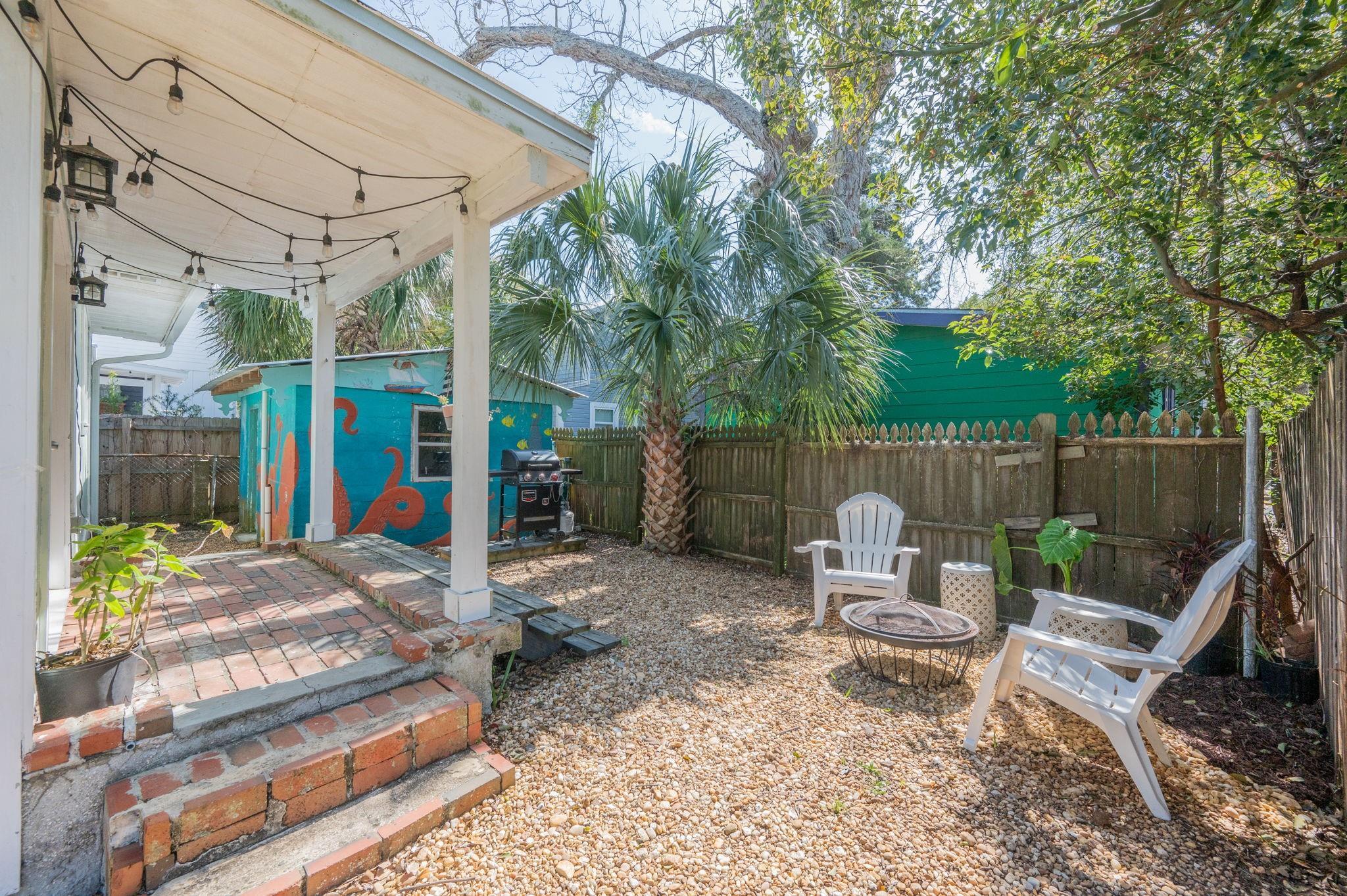 73 Kings Ferry Way St. Augustine, FL 32084 - Photo 58 of 71 a view of a patio with a table chairs and a small yard
