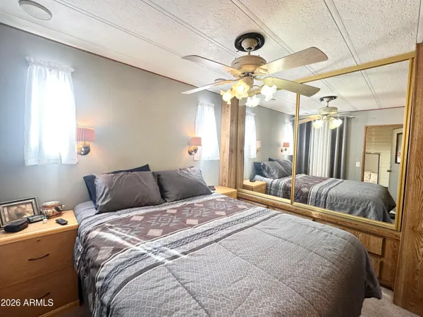 a bedroom with a bed and a chandelier