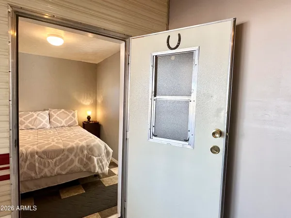a bedroom with a bed and a lamp