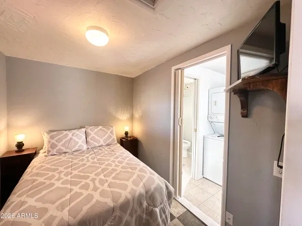 a bedroom with a bed and a flat screen tv