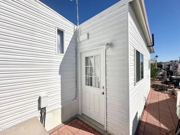 a front view of a house with a yard and tree s
