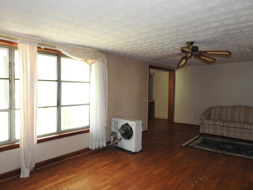 333 Lickskillet Road Epworth, GA 30541 - Photo 13 of 32 a view of an empty room with a window and hardwood floor