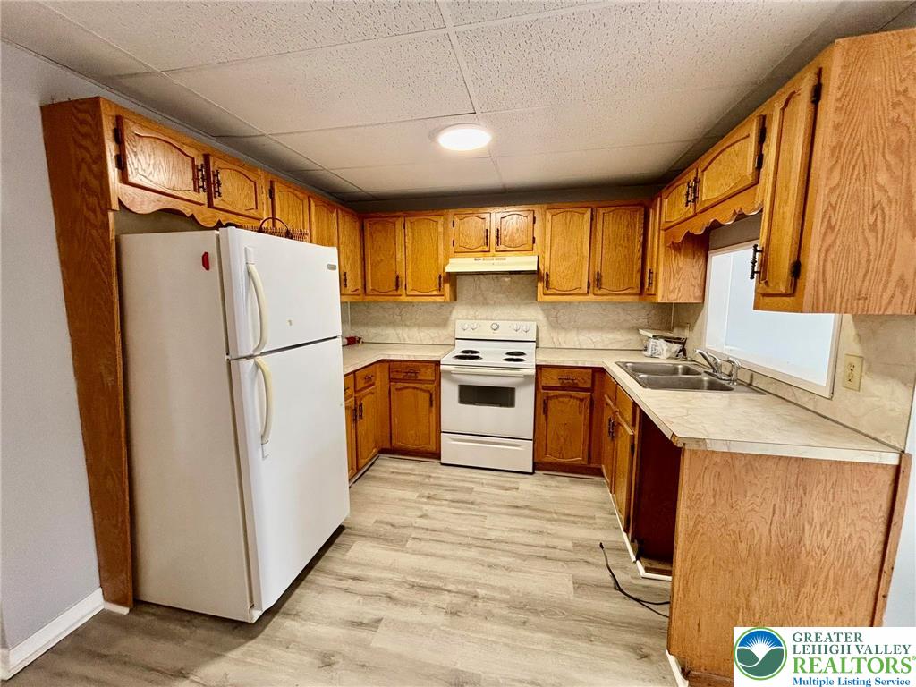 210 West Main Street Pen Argyl, PA 18072 - Photo 17 of 21 a kitchen with a refrigerator a stove top oven a sink and dishwasher