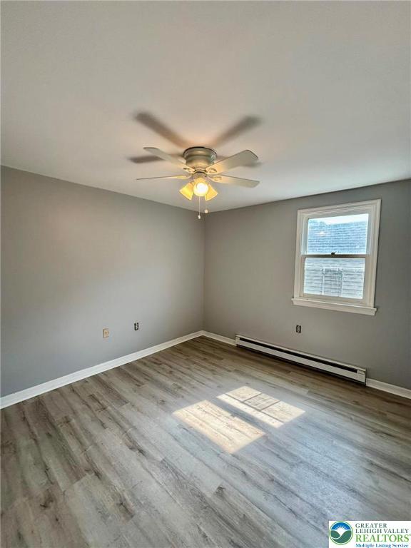 210 West Main Street Pen Argyl, PA 18072 - Photo 19 of 21 an empty room with wooden floor and chandelier fan