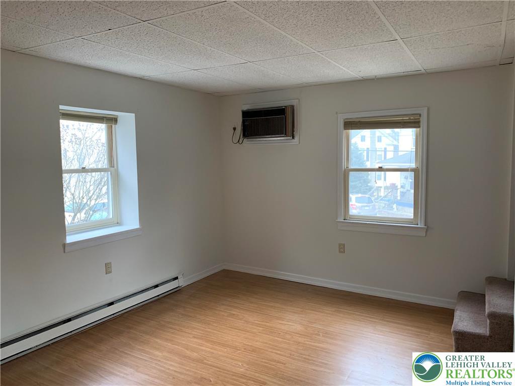 210 West Main Street Pen Argyl, PA 18072 - Photo 7 of 21 a view of an empty room with wooden floor and a window