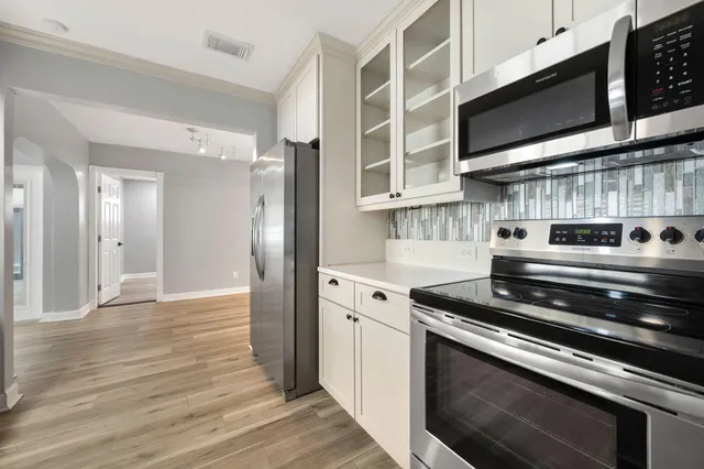 a kitchen with stainless steel appliances granite countertop a stove and a microwave