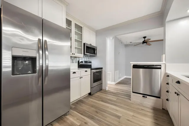 a kitchen with stainless steel appliances a refrigerator sink and stove