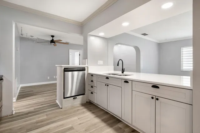 a spacious bathroom with a double vanity sink and mirror