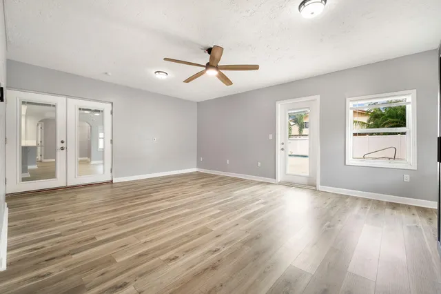 wooden floor in an empty room with a window