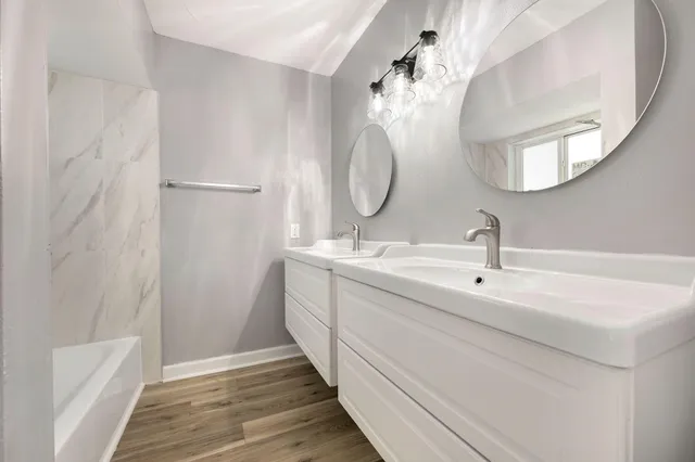 a bathroom with a double vanity sink and a mirror