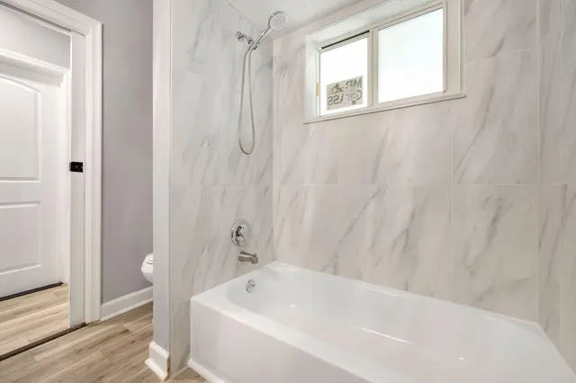 a bathroom with a bathtub and shower