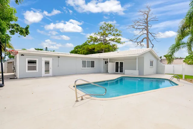 front view of house with swimming pool and sitting area
